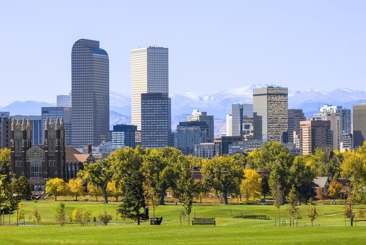 Denver Colorado skyline with Rocky Mountains behind buildings